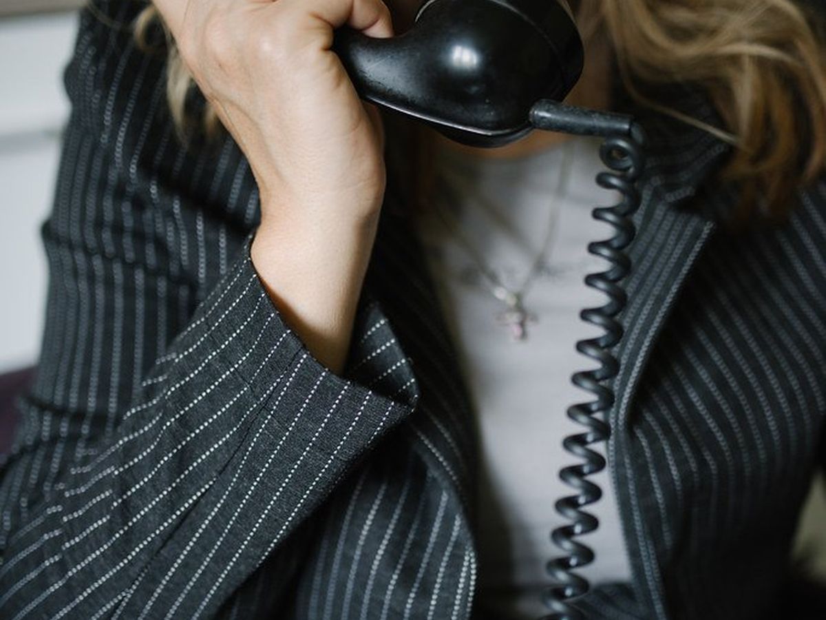 A case-desk analyst taking notes during a client call